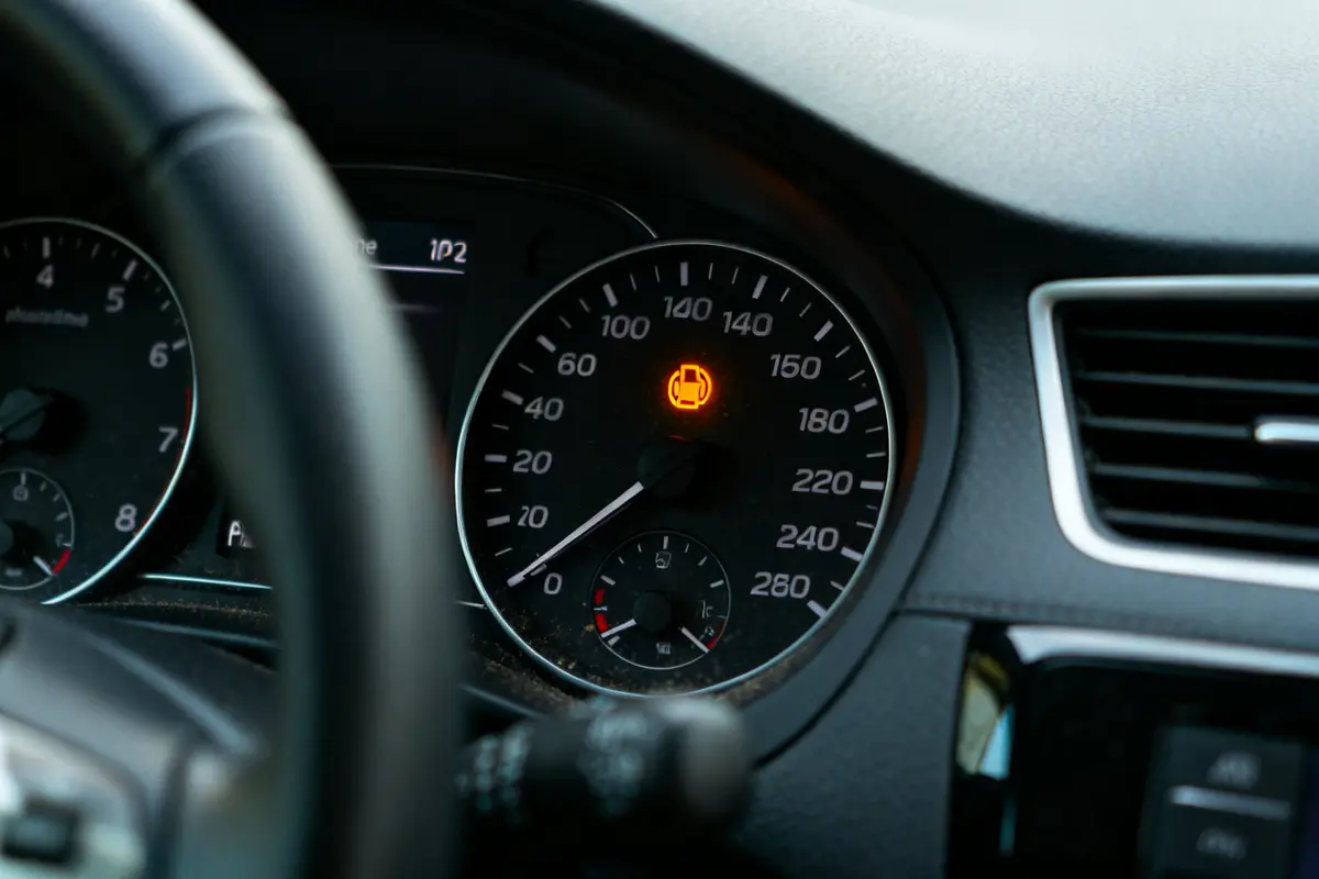 Tableau de bord de voiture avec voyant moteur allumé en orange